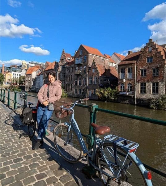 Dora standing next to a canal in Leuven on a beautiful day