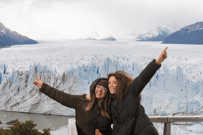 Ioanna and a friend standing in front of large glaciers in Patagonia